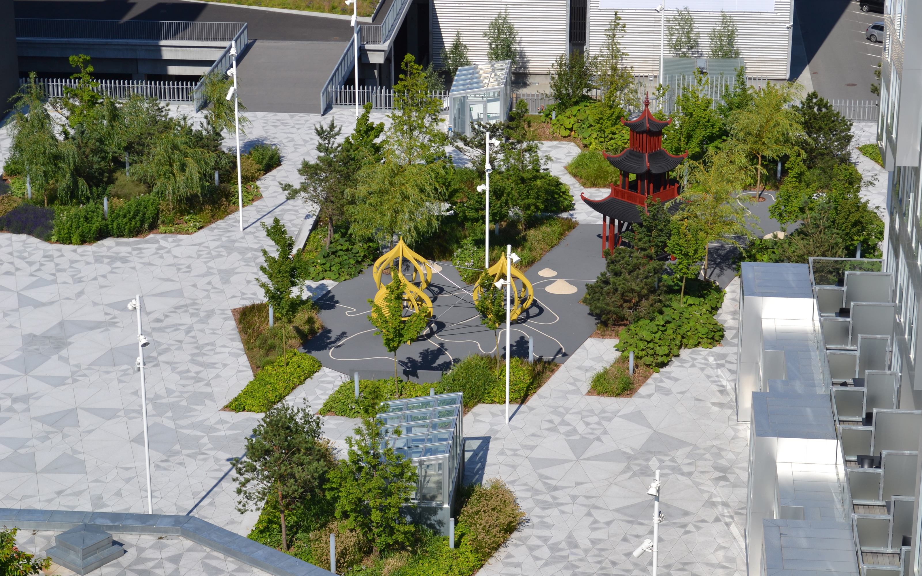 The playground was implemented on a protective rubber mat. Playground for children with Asian style playhouses